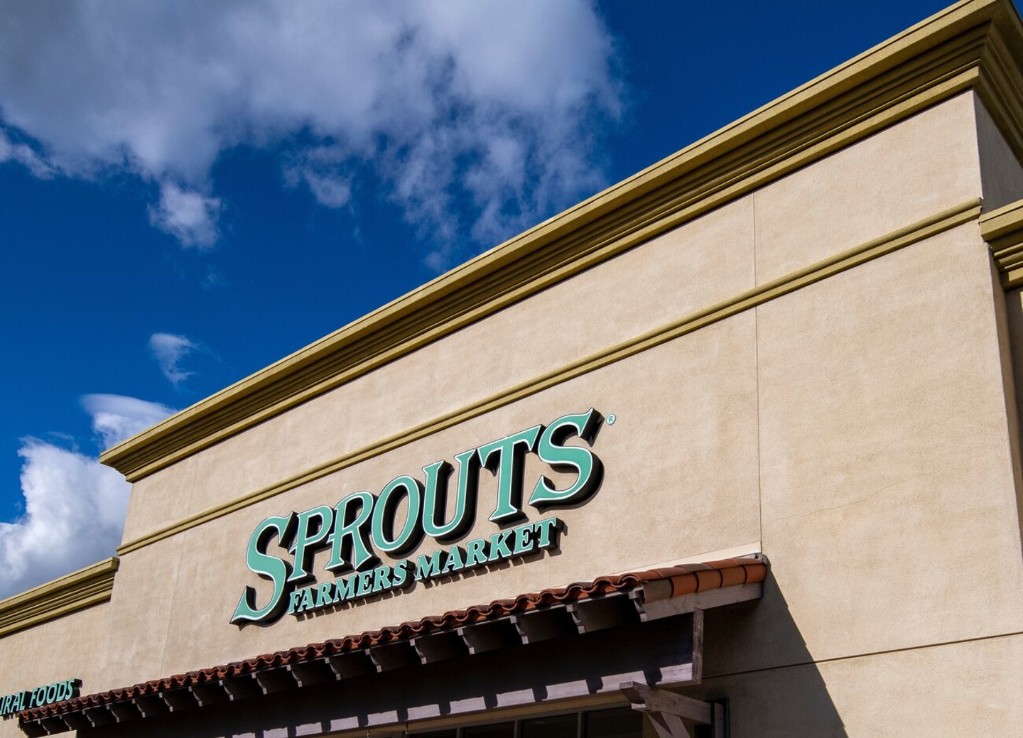 2024 Feb. 9:Valencia, California. Angle view close of Sprouts Farmers Market store front with blue sky and clouds. ; Shutterstock ID 2423627199